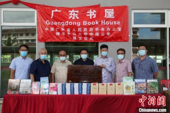  颜天禄(左四)向中国公学负责人陈展鹏(左三)、苏亚龙(右三)等移交书籍。颜天禄供图