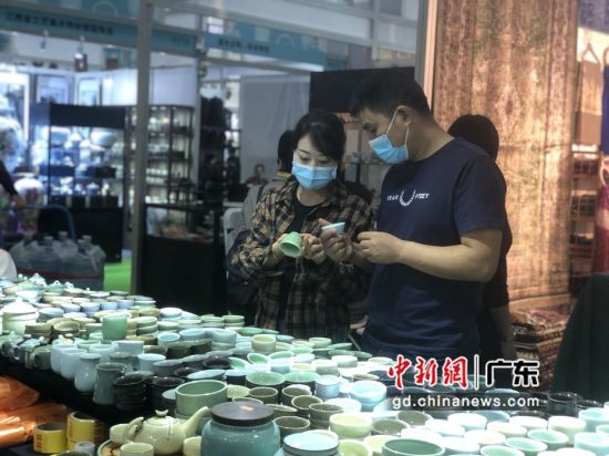 图为第25届深圳秋季茶博会现场，观众研究相关茶具。 作者 朱族英