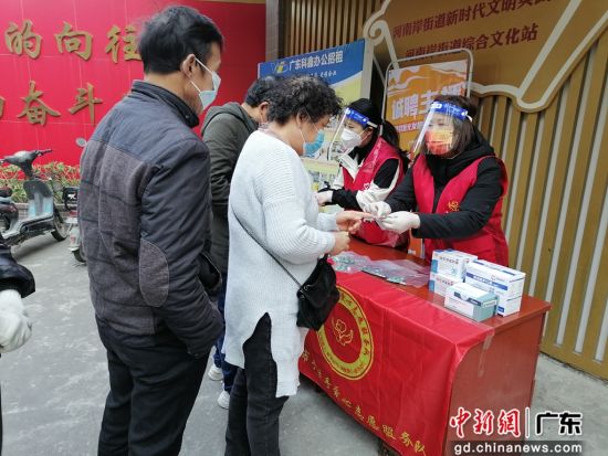 惠州市手拉手爱心志愿服务队志愿者为社区群众派药。 作者 黄素娜 摄